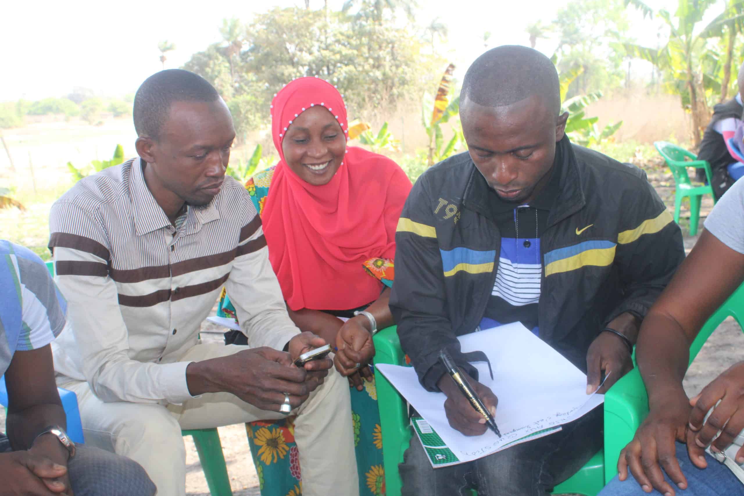 Team TREES collaborating during a community discussion outdoors.