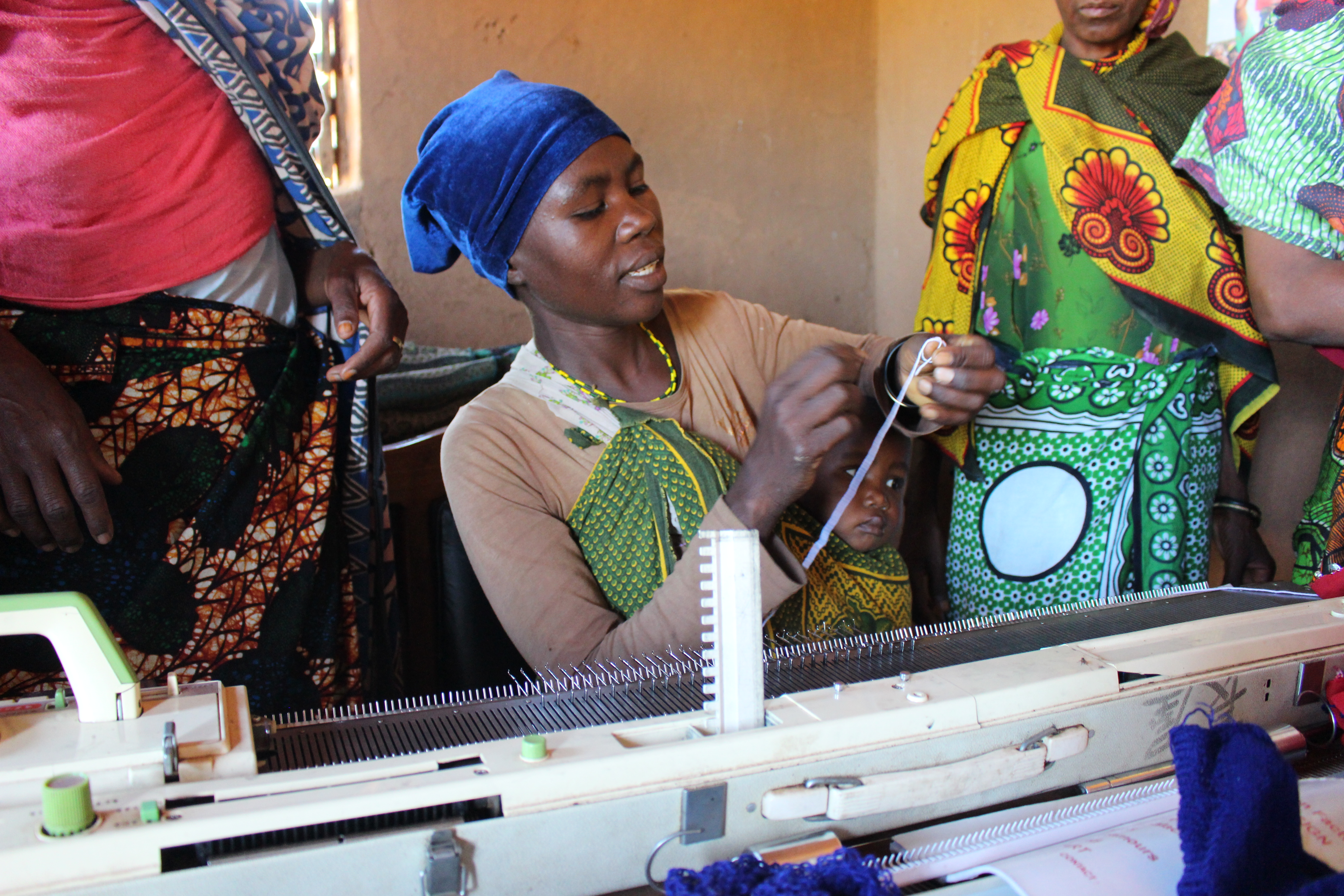 A woman from Upendo group teaching other women