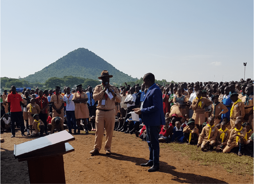 Trees for the Future representative addressing a large gathering of Kenyan Scouts during a tree planting organization event